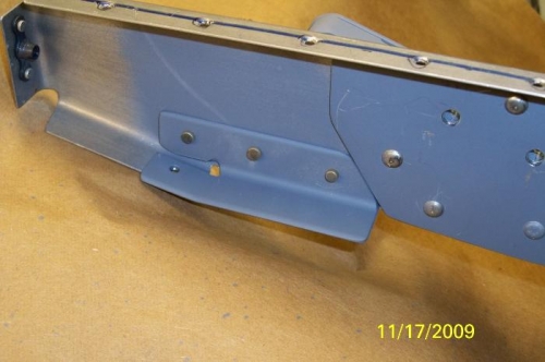 The reinforcing bracket riveted in place to the center rib