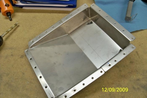 The firewall recess with nutplates riveted for the center cabin cover