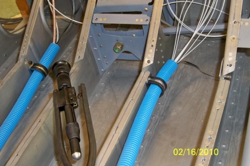 Both wiring tubes on left side clamped in place