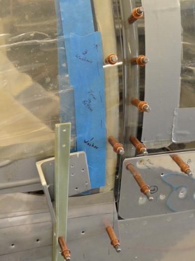 The left side of the windshield drilled to the roll bar, with notations for the number of spacers