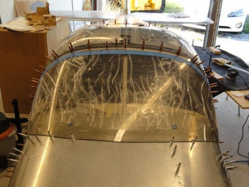 The windshield is drilled to the roll bar