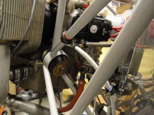 The fuel line hose and ground cable clamped to each other to prevent rubbing