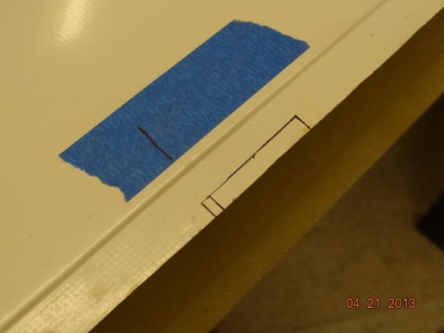 The center of the wing tip marked for trimming