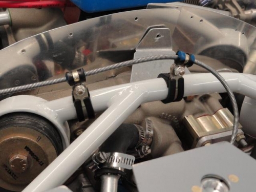 The oil cooler door cable routing across the top of the engine mount