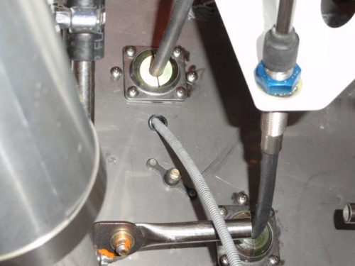 Close-up of the throttle, carb heat and mixture cables coming thru the firewall