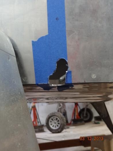 The left side of the fuselage and the initial hole