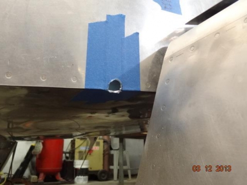 The initial hole in the right side of the fuselage