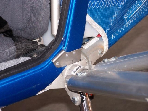 Plate riveted to fairing and door frame