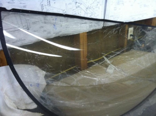 Canopy upside down on bench.  Plastic wrap removed from inside
