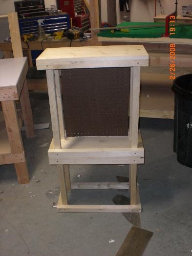 Coffee table with level for supplies and peg board for coffee cups