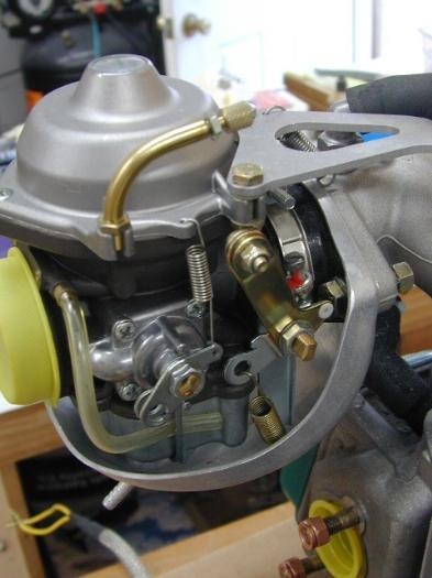 Drip cup, relocated throttle spring, and cable mounts