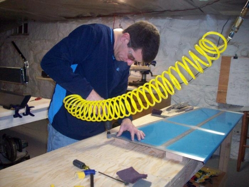 Using the scotchbrite wheel on the air drill to smooth the edges.