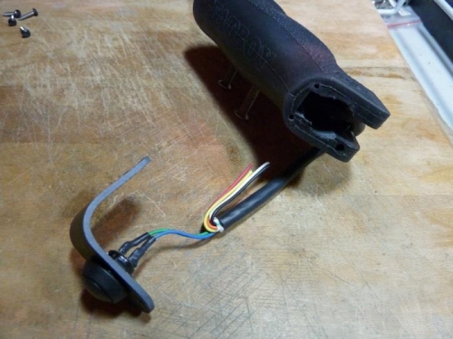 Removing the large cable from the throttle grip.