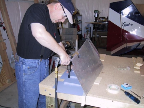 Back-riveting the stiffeners to the skin.