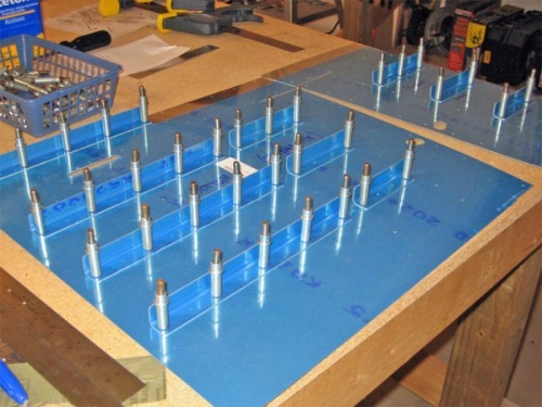 Rear floorboard stiffeners are drilled and ready for plastic removal, dimpling, priming, and riveting.