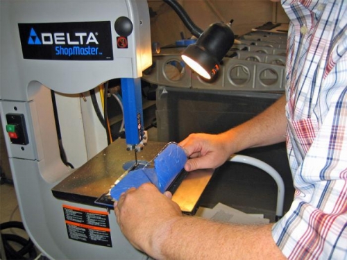 Cutting the Plexiglas lens with a bandsaw. You've heard of the hot knife and butter thing?