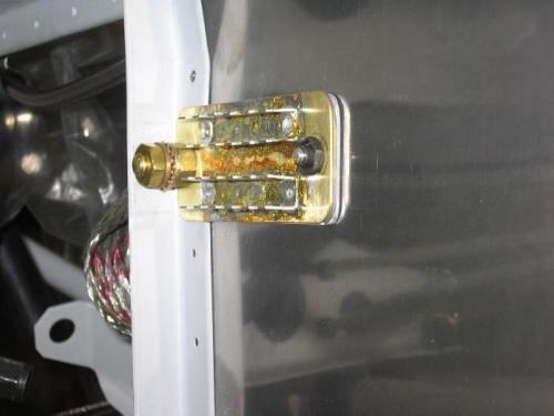 Battery negative terminal ground strap and ground block installed on the firewall