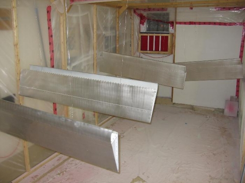 Elevators and ailerons cleaned, etched, abraded and rinsed in preparation for priming