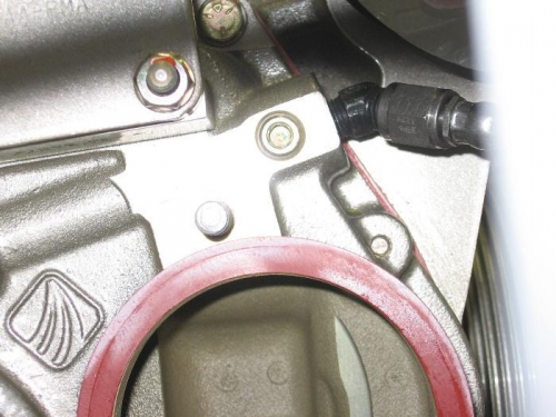 Oil pressure port restrictor fitting installed