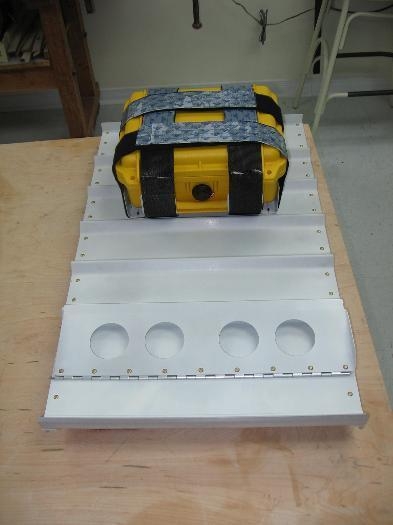 First aid and survival kit mounted to the back of the right seat backrest