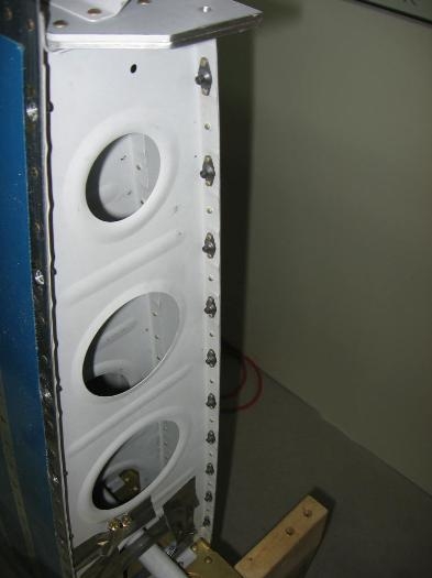 Wing root fairing anchor nuts along the bottom of the wing