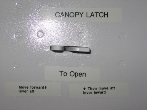 Canopy latch placarding installed inside and outside