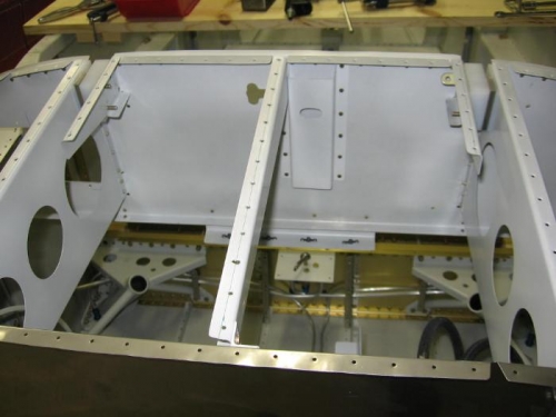 Foward upper fuselage center rib, canopy release hat section and control cable support riveted on