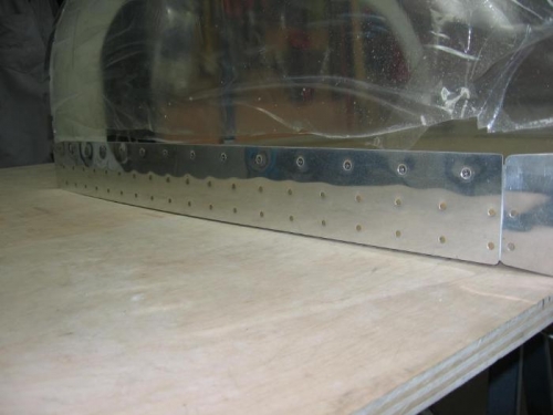 Canopy side skirt riveted on