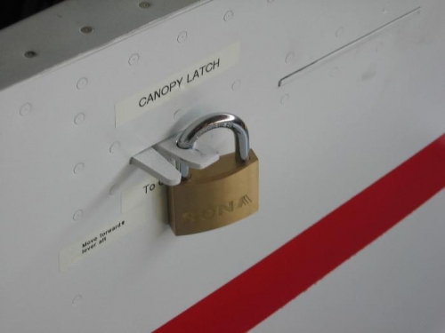 Canopy latch exterior handle drilled for a lock