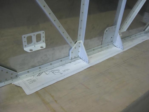 Brake bracket and fuel pump firewall doubler riveted on