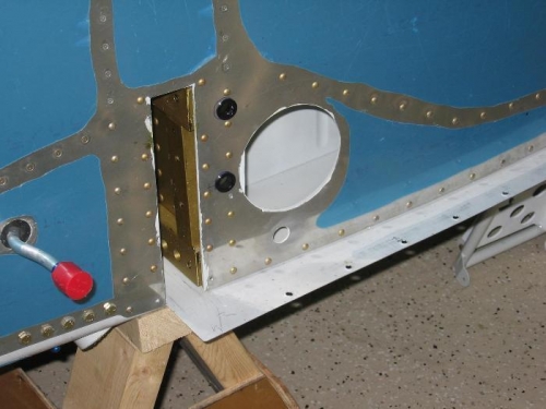 Fuselage side skin snap bushings installed for the pitot plumbing and electical wires