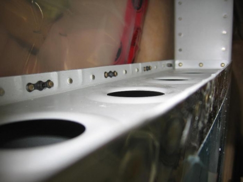 Horizontal to vertical stabilizer fairing retaining screw nut plates installed