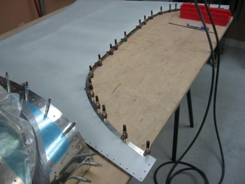 Rear window retaining screw backing strips fabricated