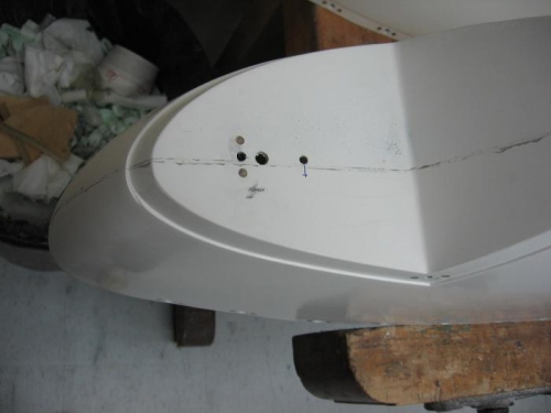 Wing tip fairing navigation light mount holes drilled and retaining screw anchor nuts installed