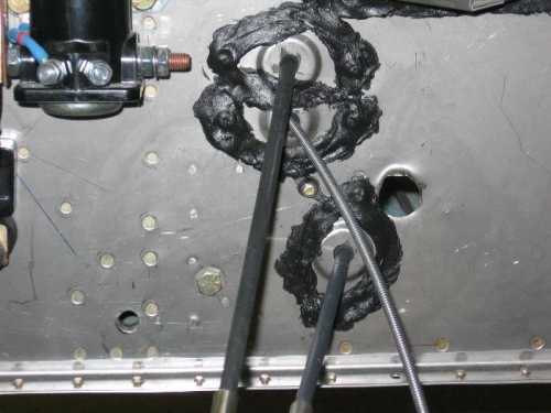 Throttle, mixture and carburetor heat control cable firewall shields installed and sealed