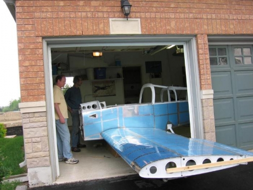 Installing the wing main spars into the fuselage center section