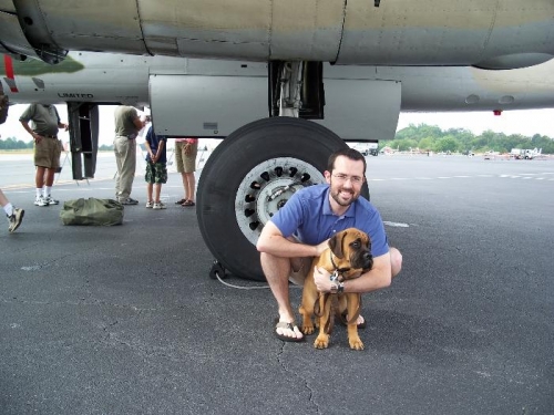 Drew and granddog Duke in front of a B-25 wheel at PDK Neighbor Day