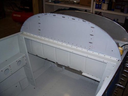 Forward baggage bin bulkhead, all riveted on