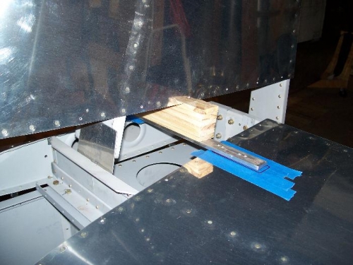 Here, I used an aluminum bar and a wooden shim pack to level the vertical stabilizer spar