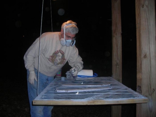 Priming the forward bulkheads on my fold down table under the deck at night