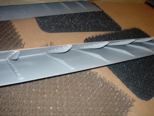 Stiffeners riveted to the aileron skins