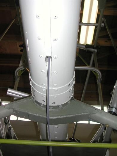 Upper elevator cable exits lower boom