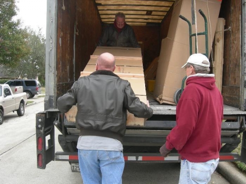 Dad (red jacket) and I unload the first crate