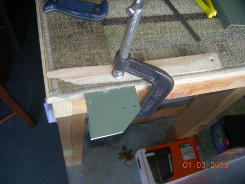Rear spar reinforcement doubler clamped to table for trimming