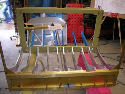 Front view, pilot and passenger seat floor, behind center rear spar. Blue ribs are the baggage bay
