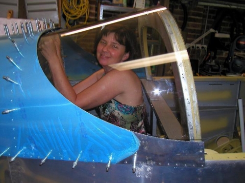 Anne-Marie holding the rear window in place so that I could mark it for the final trim