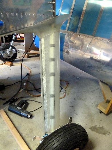 Hinge riveted and intersection fairing pushed into position.