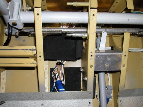 Under pilots seat wire bundle for sticks, flaps, strobes, lights etc.