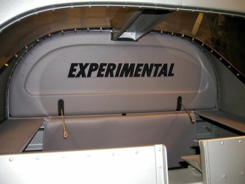 Rear baggage area tonneau cover and experimental logo insert