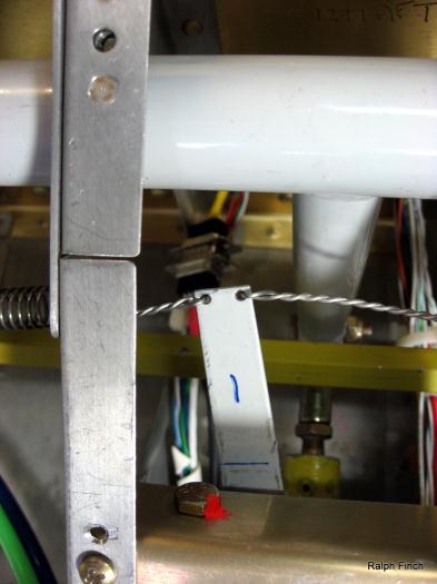 The L arm attached to servo with safety wire